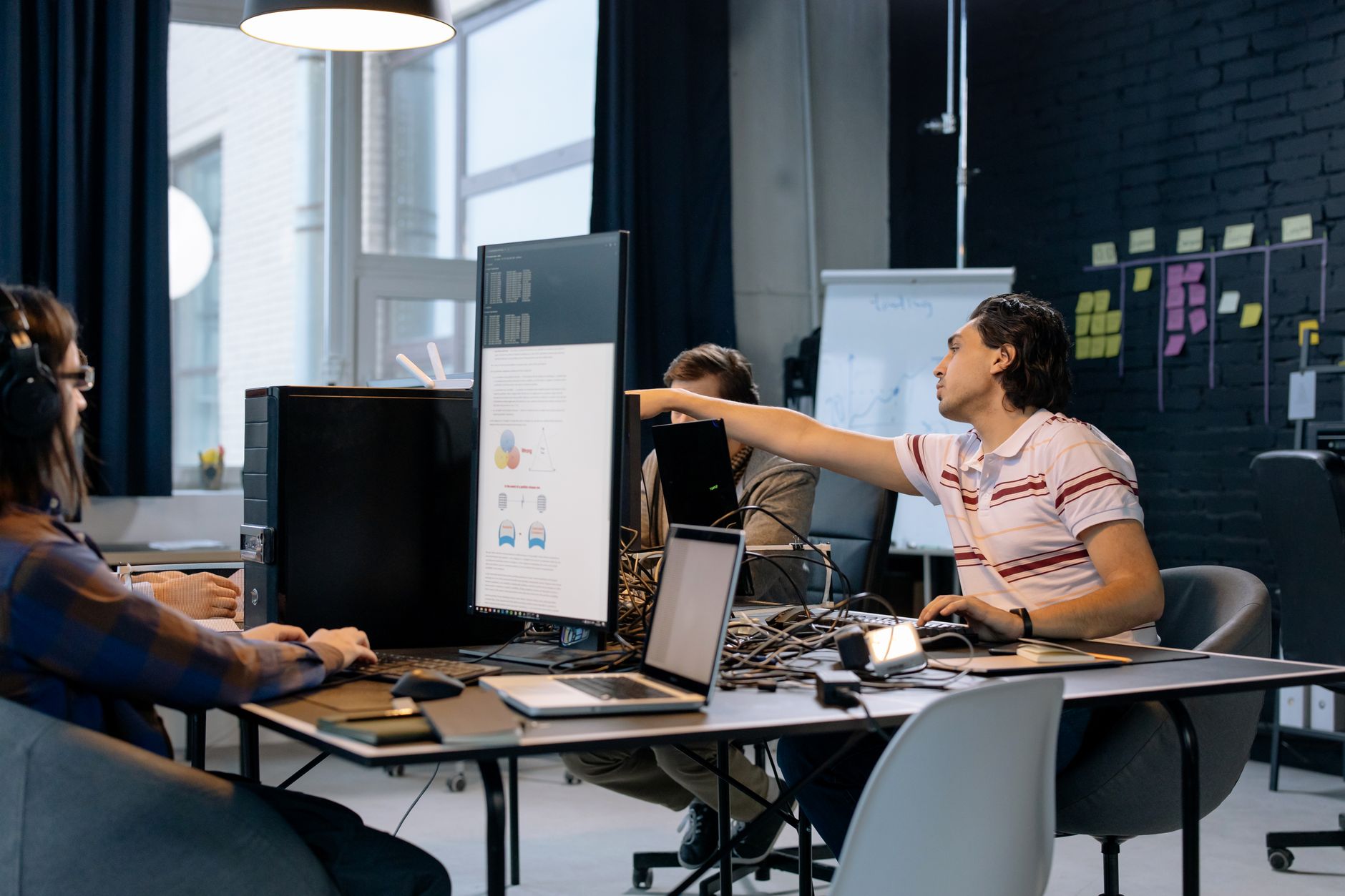 Open-plan technology company office with computers and collaborative workspaces