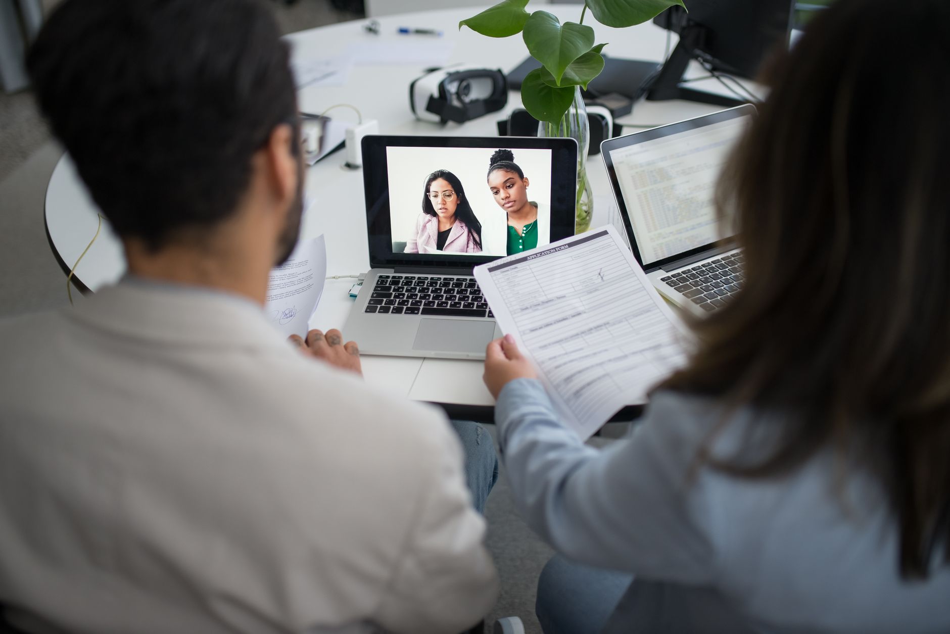 A person reviewing candidate profiles on a laptop, representing AI-assisted recruitment workflows