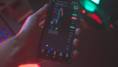 Person using a smartphone to trade cryptocurrency on a brokerage app