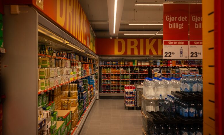 Wide retail store aisle with product shelves representing consumer goods advertising competition