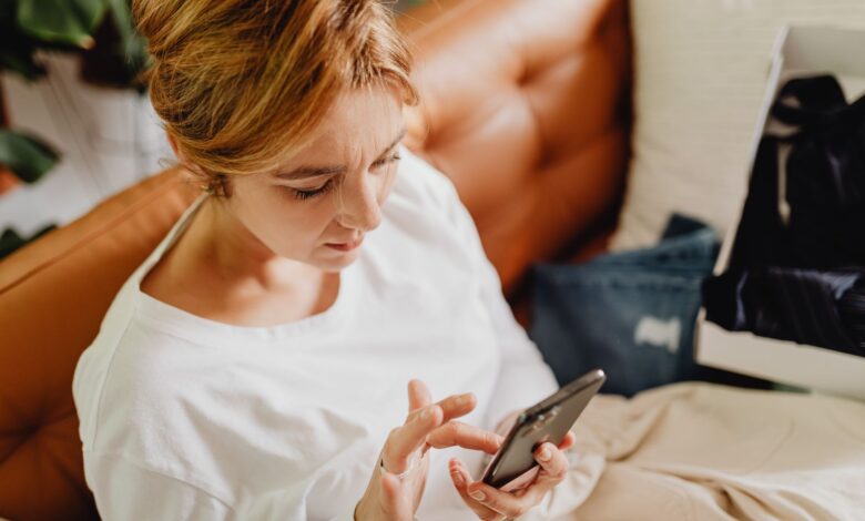 Person browsing a shopping app on a smartphone with product listings visible on screen