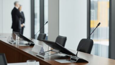 Empty corporate boardroom with large conference table representing governance restructuring discussions