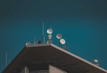 Large satellite dish pointed toward a clear blue sky representing broadband connectivity infrastructure