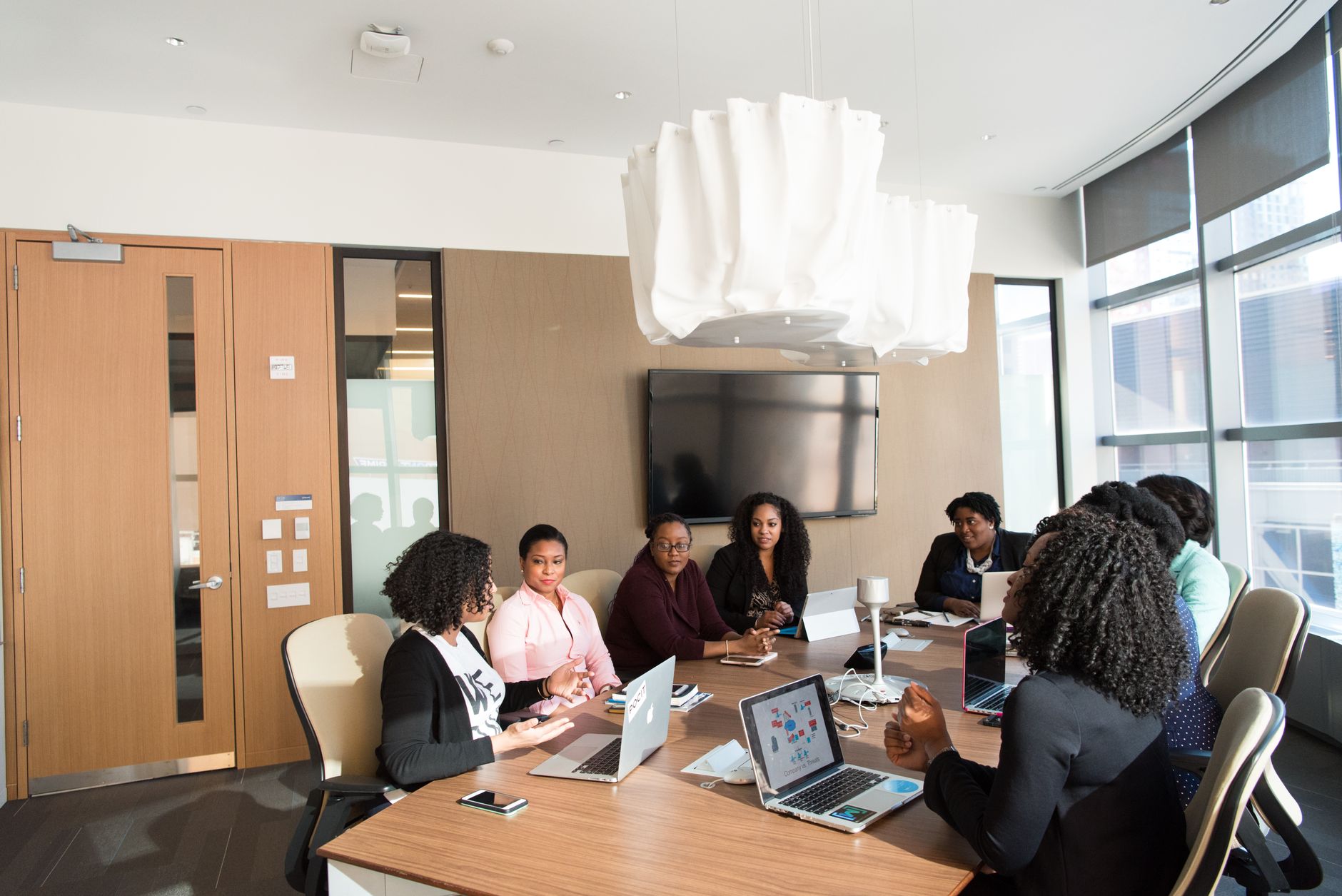 Business executives in a meeting room discussing strategic technology decisions