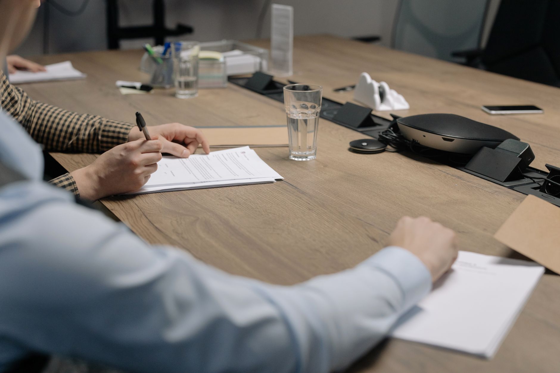 Business professionals reviewing and signing a government contract document