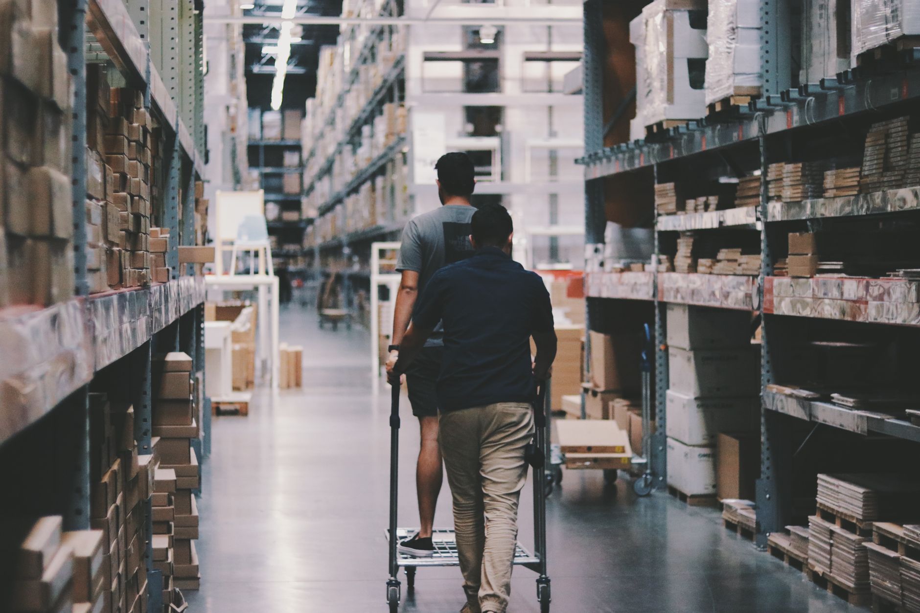 Workers organizing packages inside a large e-commerce fulfillment warehouse